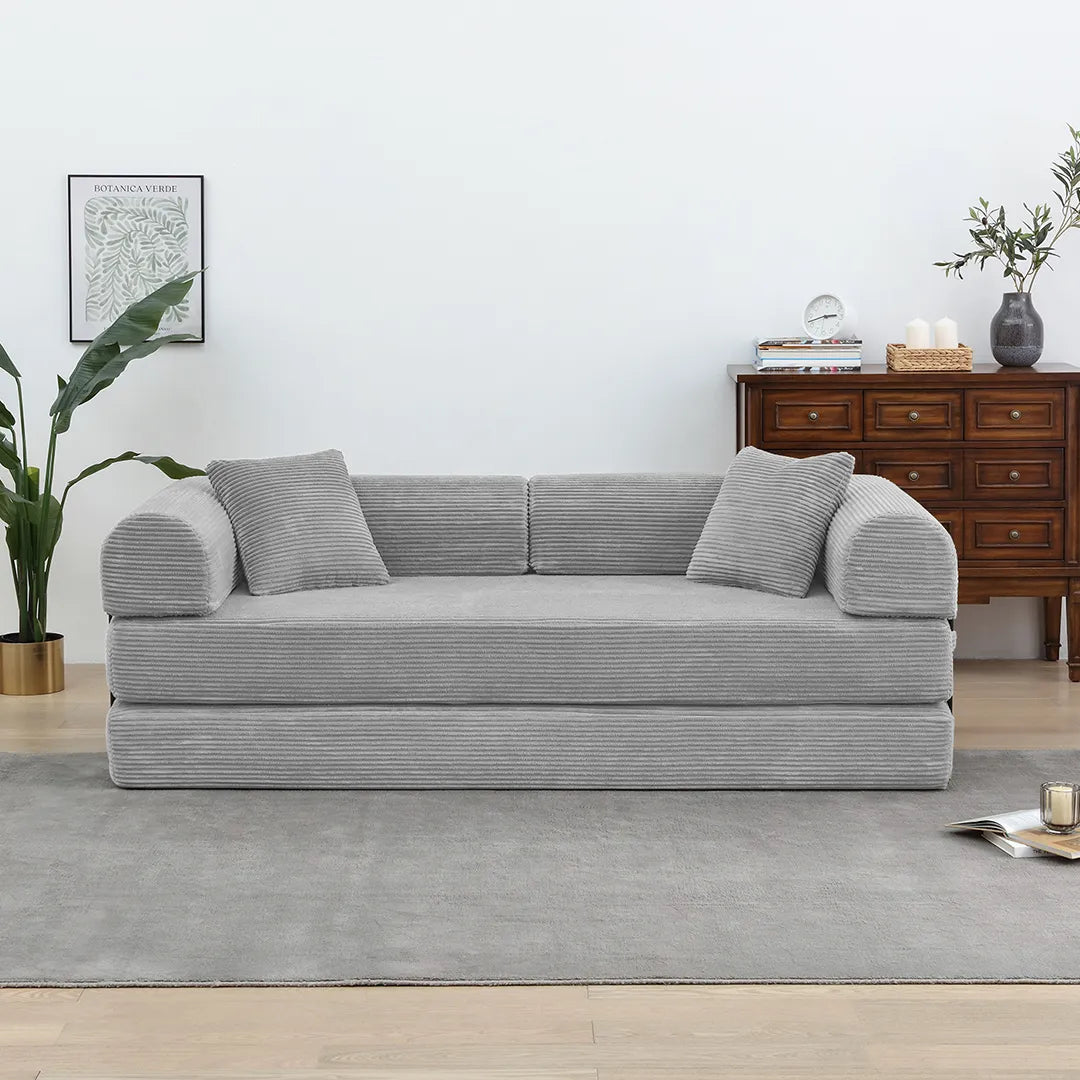 Convertible light grey floor sofa with pillows